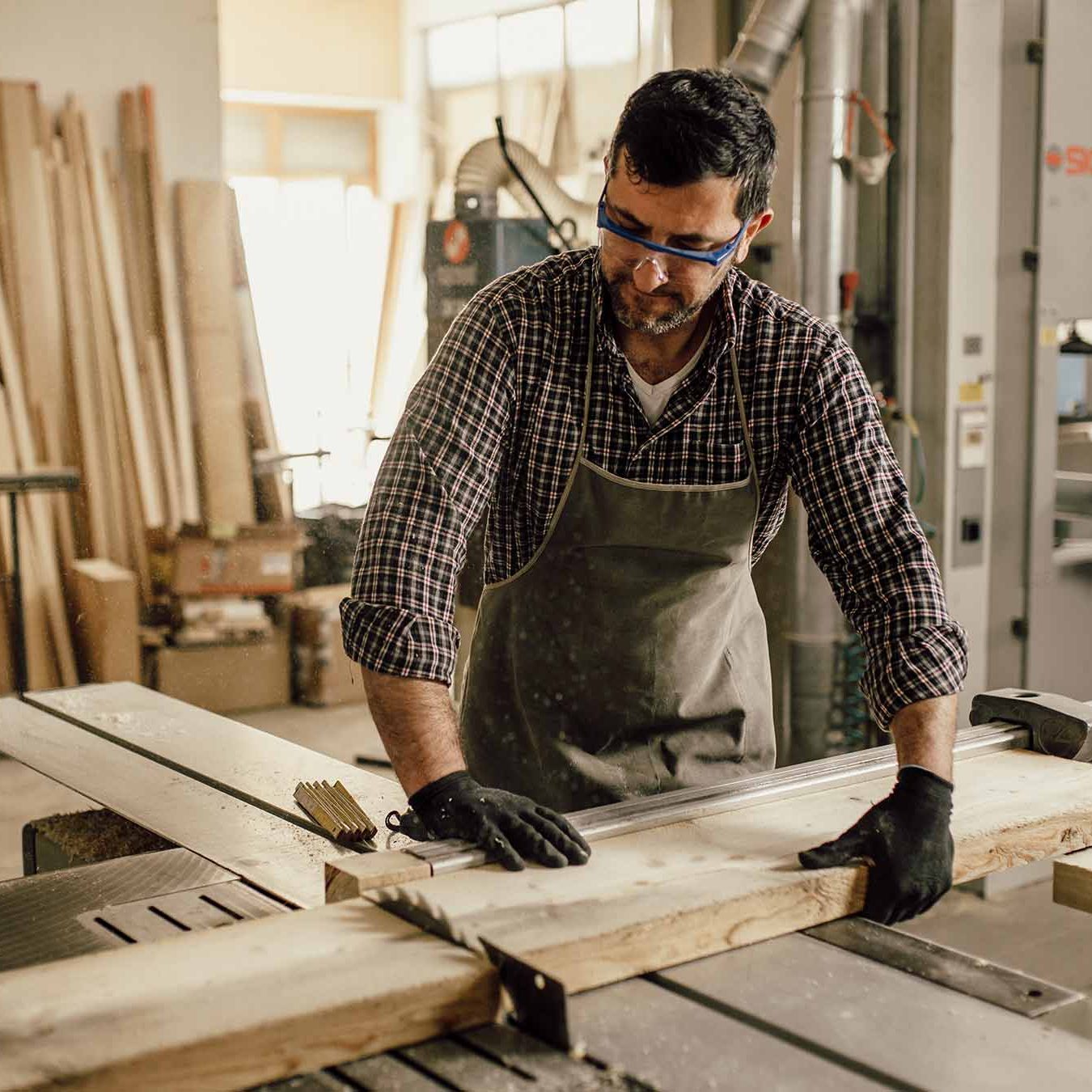 Carpenter Working With Circular Saw At Carpentry Workshop Carpenter Working With Circular Saw At Carpentry Workshop